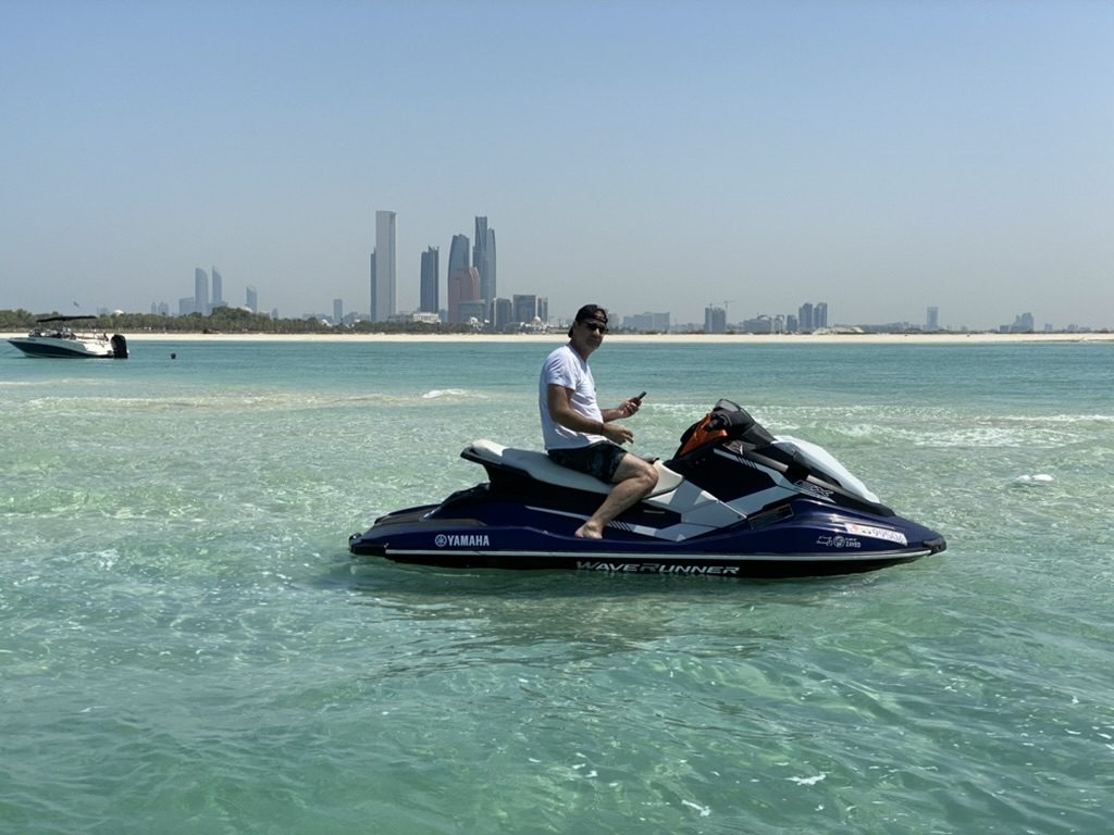Riders with the tour boat on the water