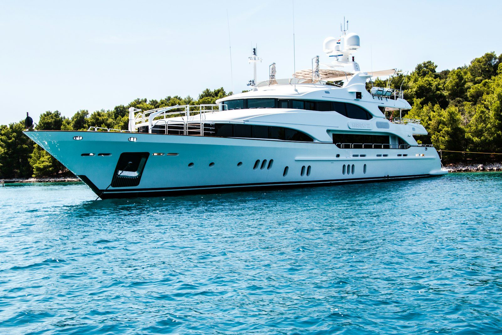 White motor yacht cruising on blue water in Abu Dhabi